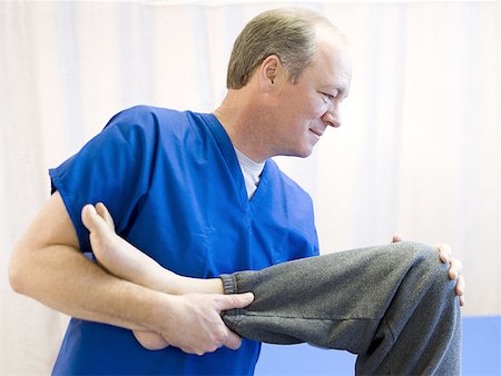 simsearch:640-03263232,k - Close-up of a male doctor assisting a physically challenged senior man undergo physical therapy Stock Photo - Premium Royalty-Free, Code: 640-01350707