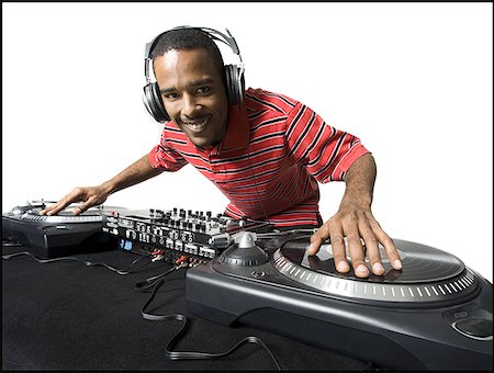 DJ with headphones spinning records Stock Photo - Premium Royalty-Free, Code: 640-01350708