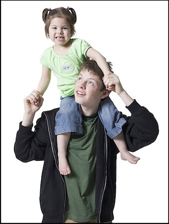 Close-up of a brother carrying his sister on his shoulders Stock Photo - Premium Royalty-Free, Code: 640-01350720