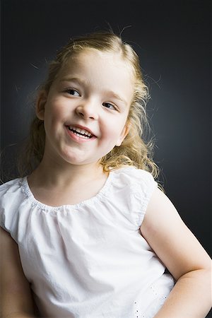 simsearch:640-01354168,k - Close-up of a girl smiling Fotografie stock - Premium Royalty-Free, Codice: 640-01350732