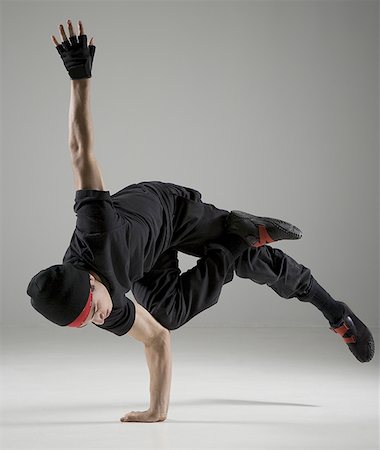 Close-up of a young man break dancing Stock Photo - Premium Royalty-Free, Code: 640-01350745