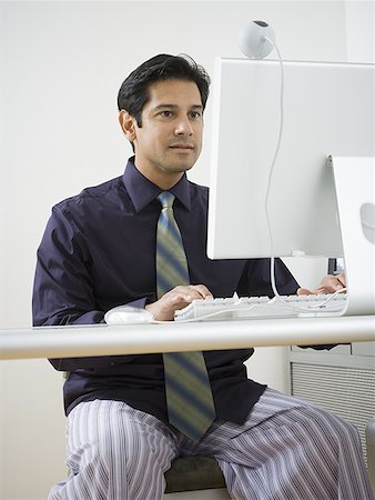 Mature man sitting in front of a video conference camera Stock Photo - Premium Royalty-Free, Code: 640-01350752