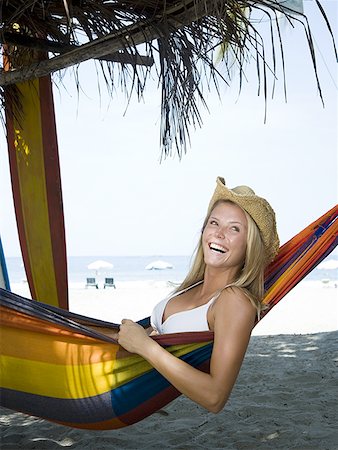 Profile of a young woman relaxing in a hammock Stock Photo - Premium Royalty-Free, Code: 640-01350767