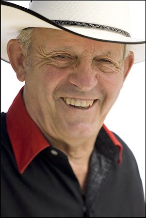 Older man in a western shirt with a cowboy hat Stock Photo - Premium Royalty-Free, Code: 640-01350913