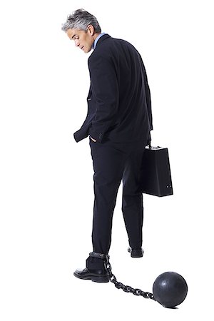 Businessman shackled to ball and chain Stock Photo - Premium Royalty-Free, Code: 640-01350959