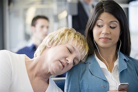 Close-up of a mature woman asleep on a young woman's shoulder Stock Photo - Premium Royalty-Free, Code: 640-01351120