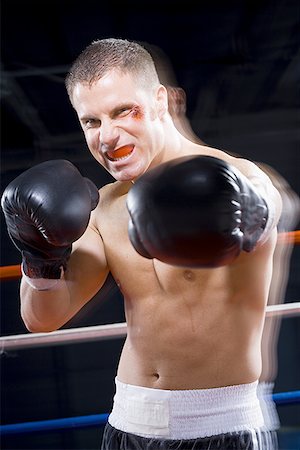 simsearch:400-07313485,k - Portrait of a young man boxing Stock Photo - Premium Royalty-Free, Code: 640-01351130