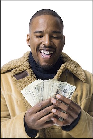 dollars money happy smiling people not illustration - African American holding a pile of dollar bills Stock Photo - Premium Royalty-Free, Code: 640-01351239