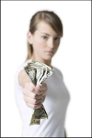 Portrait of a girl holding American dollar bills Stock Photo - Premium Royalty-Free, Code: 640-01351326