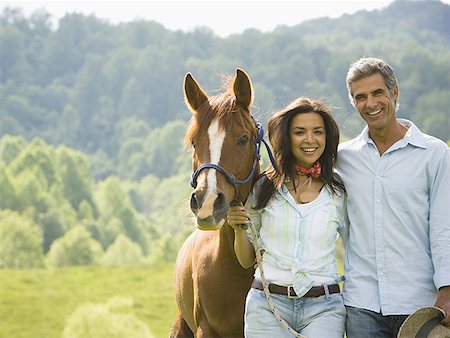 Portrait of a man and a  woman standing with a horse Stock Photo - Premium Royalty-Free, Code: 640-01351358
