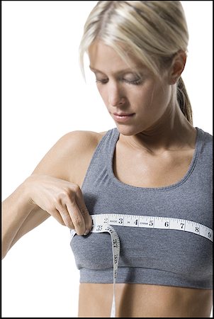 simsearch:640-01353414,k - A young woman measuring her chest with a measuring tape Stock Photo - Premium Royalty-Free, Code: 640-01351372