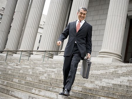 simsearch:693-03312783,k - Low angle view of a male lawyer walking down the steps of a courthouse Stock Photo - Premium Royalty-Free, Code: 640-01351408