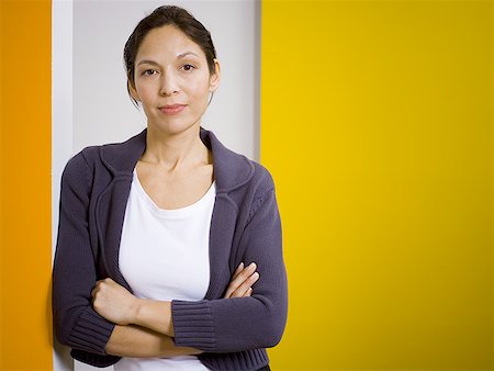 Portrait of a woman standing with her arms folded Stock Photo - Premium Royalty-Free, Code: 640-01351463