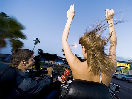 Rear view of a young couple sitting in a car Stock Photo - Premium Royalty-Free, Code: 640-01351478