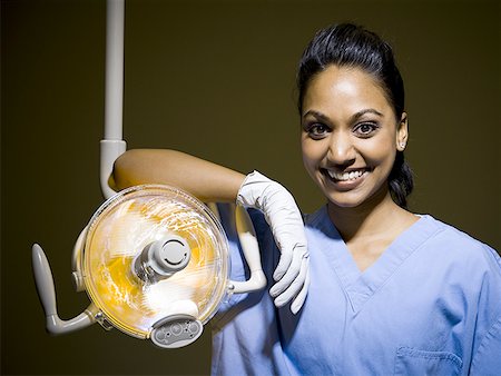 Woman in nurses uniform leaning on medical light Stock Photo - Premium Royalty-Free, Code: 640-01351520