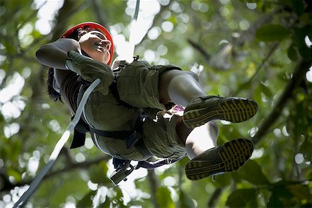 simsearch:841-05782733,k - Low angle view of a young woman rappelling in the jungle Stock Photo - Premium Royalty-Free, Code: 640-01351657
