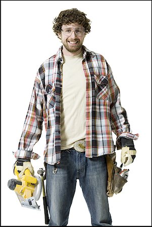 simsearch:640-01359391,k - Portrait of a young man wearing a tool belt and holding a circular saw Foto de stock - Royalty Free Premium, Número: 640-01351661