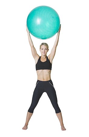 simsearch:640-01359251,k - Portrait d'une jeune femme tenant un ballon de fitness Photographie de stock - Premium Libres de Droits, Code: 640-01351746