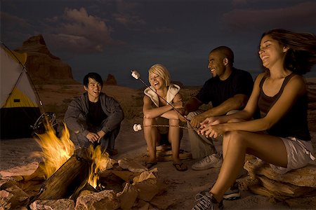 Two couples sitting by a campfire Stock Photo - Premium Royalty-Free, Code: 640-01351776