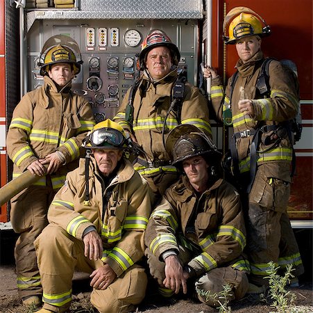 fireman portrait - Portrait of five firefighters standing in front of a fire engine Stock Photo - Premium Royalty-Free, Code: 640-01351936