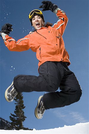 Low angle view of an adult woman jumping Stock Photo - Premium Royalty-Free, Code: 640-01352066