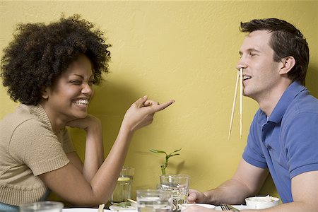 Profile of a young couple sitting at the dining table Stock Photo - Premium Royalty-Free, Code: 640-01352068