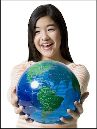 Close-up of a teenage girl holding a globe Stock Photo - Premium Royalty-Free, Code: 640-01352217