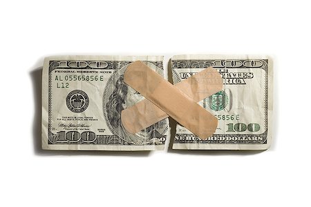 Torn US one hundred dollar bill with bandages Stock Photo - Premium Royalty-Free, Code: 640-01352286