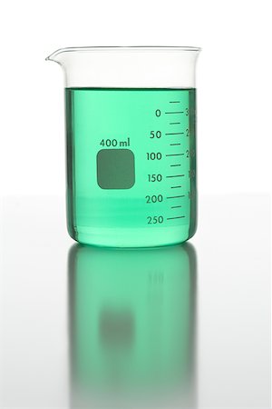 Close-up of a beaker filled with green liquid Stock Photo - Premium Royalty-Free, Code: 640-01352313