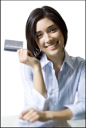 simsearch:640-01348337,k - Portrait of a young woman holding a credit card Fotografie stock - Premium Royalty-Free, Codice: 640-01352386