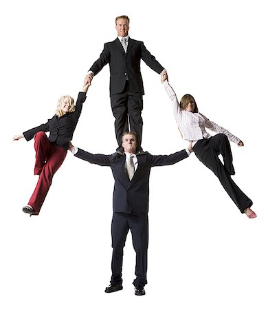 Business people creating a human pyramid Stock Photo - Premium Royalty-Free, Code: 640-01352387