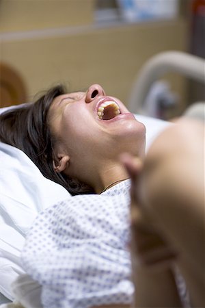 person in hospital bed overhead - High angle view of a female patient showing uncomfortable expression Stock Photo - Premium Royalty-Free, Code: 640-01352383