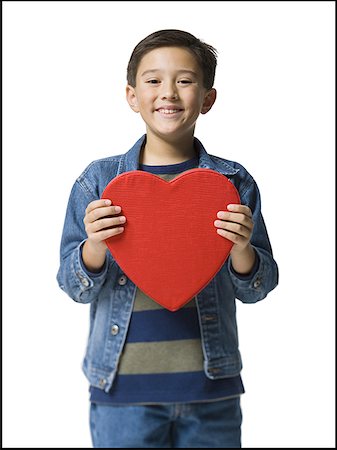 Portrait of a boy holding a heart Stock Photo - Premium Royalty-Free, Code: 640-01352488