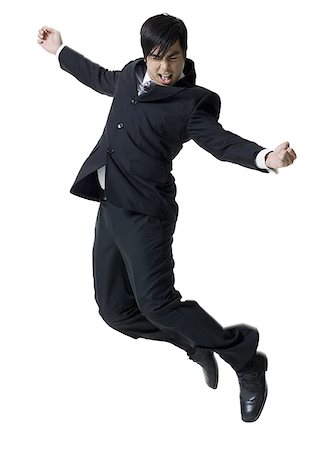 simsearch:640-01360385,k - Profile of a businessman jumping in mid air with his arms outstretched Stock Photo - Premium Royalty-Free, Code: 640-01352491