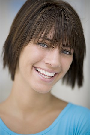 Close-up of a teenage girl smiling Stock Photo - Premium Royalty-Free, Code: 640-01352502