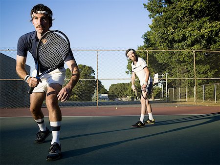 Two young men playing tennis Stock Photo - Premium Royalty-Free, Code: 640-01352516