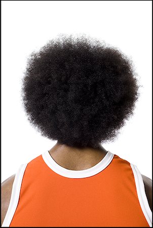 Basketball player with an afro in orange uniform Stock Photo - Premium Royalty-Free, Code: 640-01352594