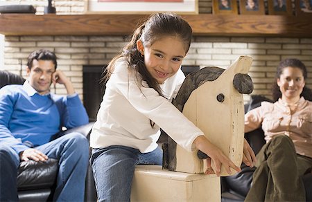 simsearch:640-01348661,k - Portrait d'une jeune fille sur un cheval à bascule Photographie de stock - Premium Libres de Droits, Code: 640-01352624