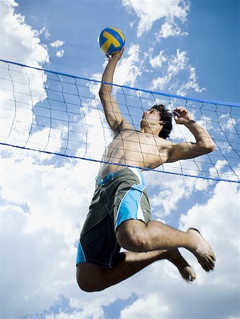 Jumping volleyball players Fotografie stock - Premium Royalty-Free, Codice: 640-01352678