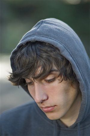 sad picture of a teenage boy alone - Close-up of a teenage boy thinking Stock Photo - Premium Royalty-Free, Code: 640-01352684