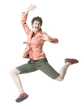 simsearch:640-01354318,k - Portrait of a young woman jumping in mid air Foto de stock - Sin royalties Premium, Código: 640-01352688