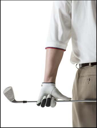 simsearch:640-01353029,k - Milieu vue en coupe d'un homme adult moyen tenant un bâton de golf Photographie de stock - Premium Libres de Droits, Code: 640-01352779