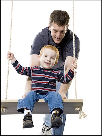 simsearch:640-01356740,k - Father pushing his son on a swing Fotografie stock - Premium Royalty-Free, Codice: 640-01352867