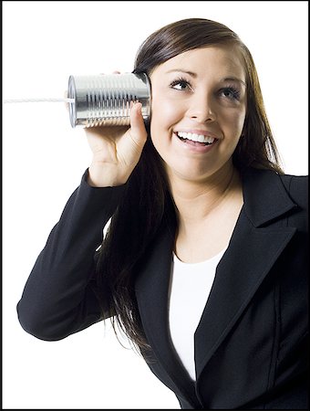 Close-up of a teenage girl holding a tin can phone up to her ear Foto de stock - Sin royalties Premium, Código: 640-01352872