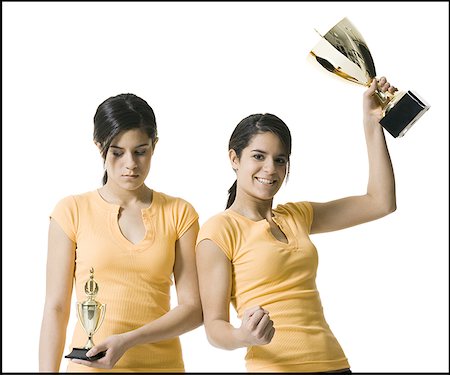 sibling sad - Close-up of two teenage girls holding trophies Stock Photo - Premium Royalty-Free, Code: 640-01353042