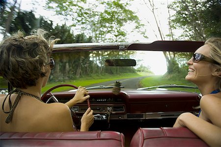 road side grass - Close-up of two young women wearing sunglasses driving a car Stock Photo - Premium Royalty-Free, Code: 640-01353105