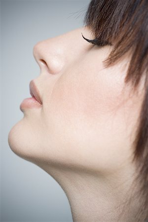 Close-up of a young woman with her eyes closed Stock Photo - Premium Royalty-Free, Code: 640-01353171