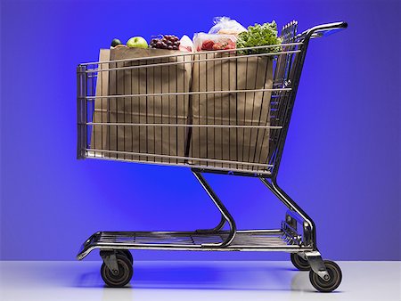 shopping bag shopping cart - Close-up of a shopping cart with groceries Stock Photo - Premium Royalty-Free, Code: 640-01353362