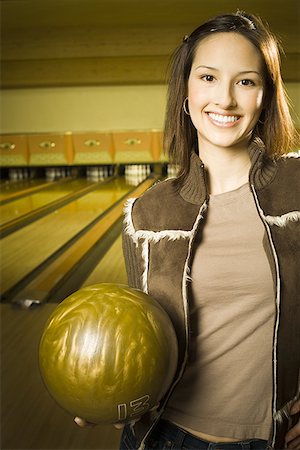 simsearch:640-03265586,k - Portrait of a teenage girl holding a bowling ball and smiling Stock Photo - Premium Royalty-Free, Code: 640-01353531