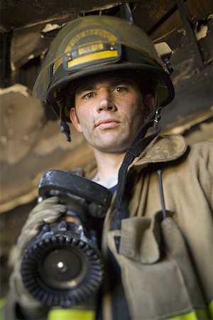 simsearch:640-01359145,k - Low angle view of a firefighter holding a fire hose Stock Photo - Premium Royalty-Free, Code: 640-01353548